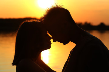 boy and  girl on a beach sunrise 