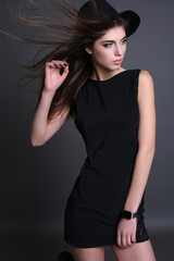 gorgeous sensual woman with dark straight hair wears elegant clothes