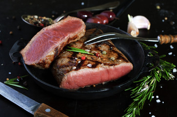Grilled beef steak with spices, garlic and rosemary