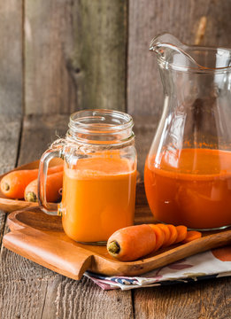Glass and jar of carrot juice