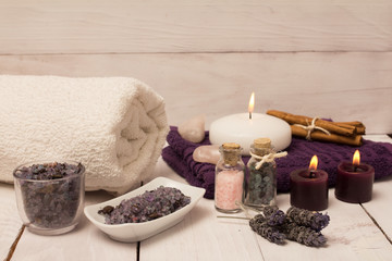 Obraz na płótnie Canvas Lavender flower and bath salts spa, two purple candles and a white towel