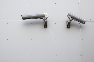 Security camera on the gray wall.