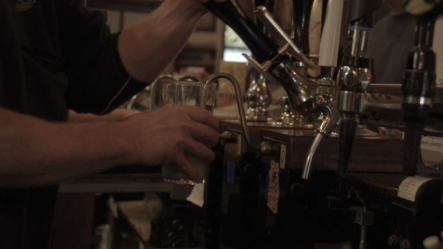 Bartender Pulling A Pint In A British Pub