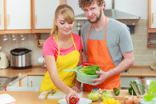 Couple preparing fresh vegetables food salad