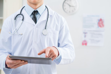 Professional doctor holding tablet 