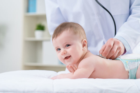 Professional Pediatrician Examining Infant 