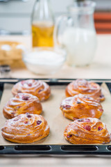 Baking tray with buns standing on the table 