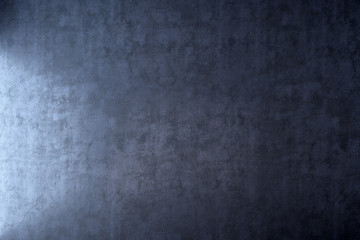 Obraz na płótnie Canvas Dark wall with light effect in blue plaster