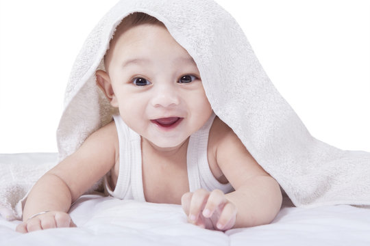 Joyful Baby Lying under A Towel