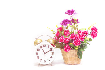 Alarm clock with flower on white background,hight key