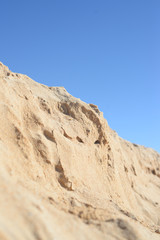 Fototapeta na wymiar Hot and dusty landscape bleaching in hot sun with mountain