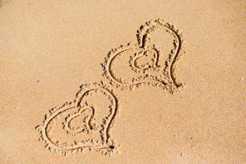 Double Love hearts impression on the sand background