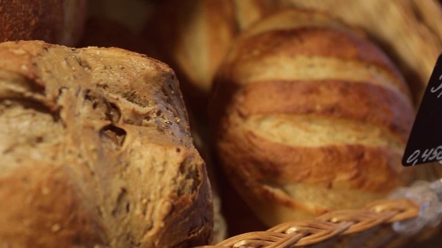 Fresh crispy bread sticks, buns, and  baguettes on the counter in the grocery shop or bakery. Farinaceous foods