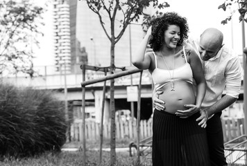 Cheerful and beautiful couple expecting baby black and white