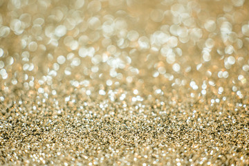 Festive gold glitter blur bokeh background; selective focused