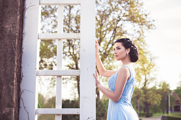 Portrait of sensual fashion young woman in blue dress