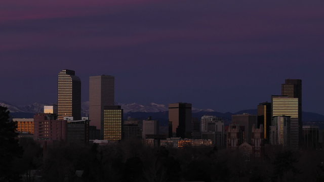 The first light of the morning sun reflects off of skyscrapers in downtown Denver, Colorado. HD 1080p time-lapse.