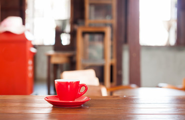 Red coffee cup on wooden table
