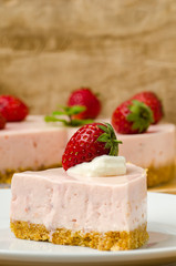 Homemade strawberry cheesecake  on white plate