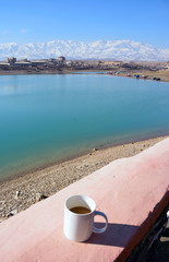 Drinking coffee at lakeside