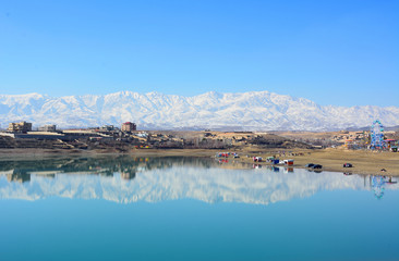 Lake reflecting mountains covered in snow