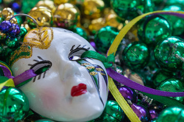 Macro Mardi Gras beads with white ceramic mask face