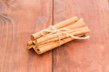 Cinnamon sticks on a wooden surface