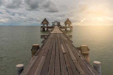 Wood bridge on sea at sunset