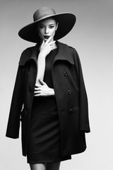 high fashion portrait of elegant woman in black  hat and coat.