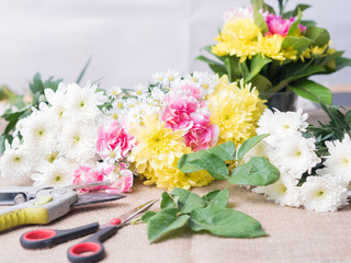 Obraz na płótnie Canvas Scissor on table of flowers arrangement.