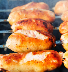 Fried sausages on the grill.