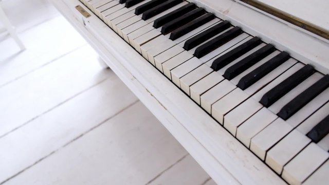 Piano keyboard video shooting. Cozy white interior