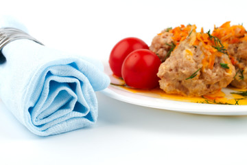 Blue cloth napkin and a plate of meat balls
