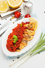 Slices of marinated grilled fish, on oval plate.
