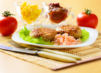 Meat chops with the peeled shrimp.