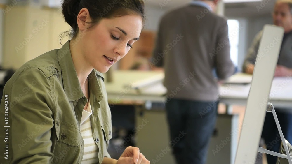 Wall mural Portrait of young engineer working on desktop computer