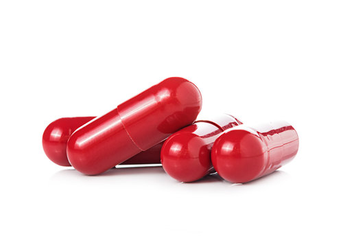 Red Pill Capsules On White Background
