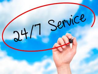 Man Hand writing 24/7 Service with black marker on visual screen