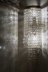 Brass sconces with crystal. Lighted sconces with crystal pendants.