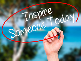 Man Hand writing Inspire Someone Today with black marker on visu