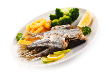 Fried herrings, chips and vegetables