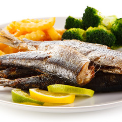 Fried herrings, chips and vegetables