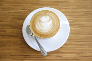 Hot Cappuccino with white cup on wood table coffehouse