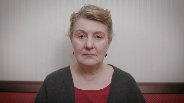 Elderly women and feelings, portrait of serious senior caucasian woman with severe look staring at camera.