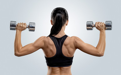 Fitness woman in training muscles of the back with dumbbells