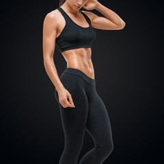 Obraz na płótnie Canvas Fitness sporty woman showing her well trained body