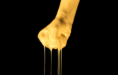 Painted hand. Hands dripped in color paint isolated on black.