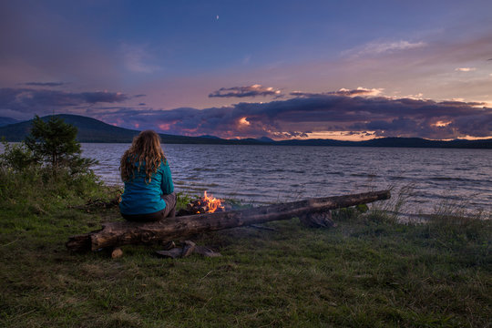 22 july 2015, lake Zuratkul, Chelyabinskaya obl, Russia. A woman admiring the sunset over the lake.