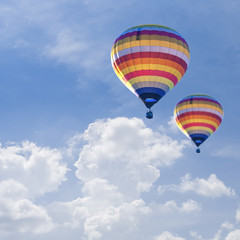 Hot air balloons on Blue sky background with white cloud.