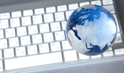 Cristal globe of the Earth on a Computer